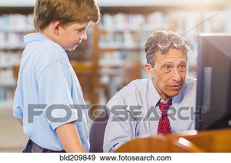 Teacher and student working at computer View Large Photo Image Stock Photo - Teacher and student working at computer. Fotosearch
