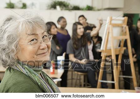Stock Photo - Teacher and students in art class. Fotosearch