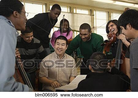 Teacher talking to high school orchestra students View Large Photo Image Stock Photography - Teacher talking to high school orchestra students. Fotosearch