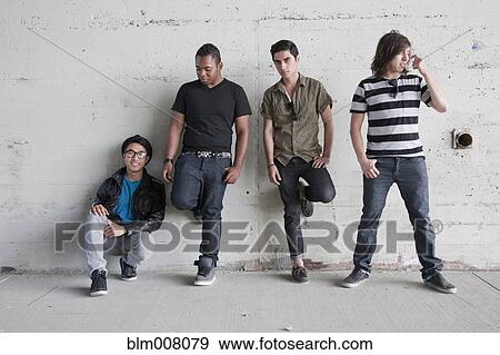 Teenage boys leaning against wall View Large Photo Image Stock Photo - Teenage boys leaning against wall. Fotosearch