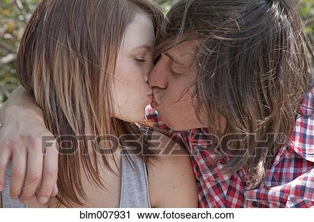 Teenage couple kissing View Large Photo Image Stock Image - Teenage couple kissing. Fotosearch