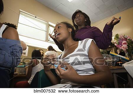 Stock Image - Teenage girls getting ready backstage. Fotosearch
