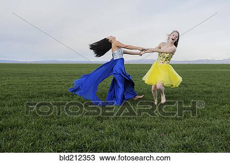 Teenage girls wearing gown in rural field View Large Photo Image Stock Image - Teenage girls wearing gown in rural field. Fotosearch
