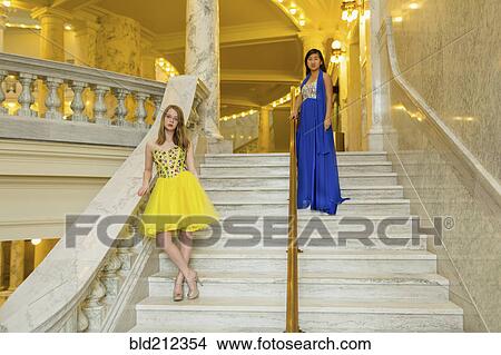 Picture - Teenage girls wearing gowns on ornate staircase. Fotosearch