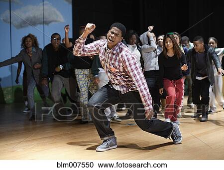 Stock Image - Teenagers rehearsing on stage. Fotosearch