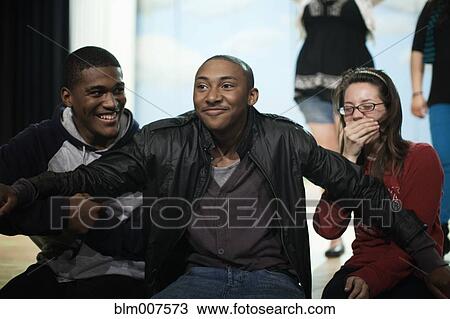 Stock Image - Teenagers rehearsing on stage. Fotosearch