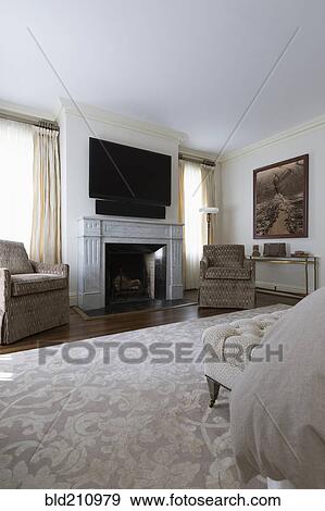 Stock Photo - Television and armchairs in ornate bedroom. Fotosearch