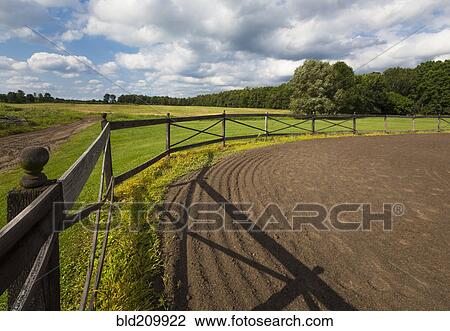 Stock Image - Tire tracks in riding ring on horse farm. Fotosearch