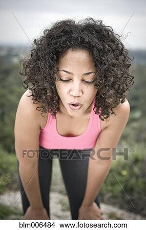Picture - Tired woman resting after exercise. Fotosearch