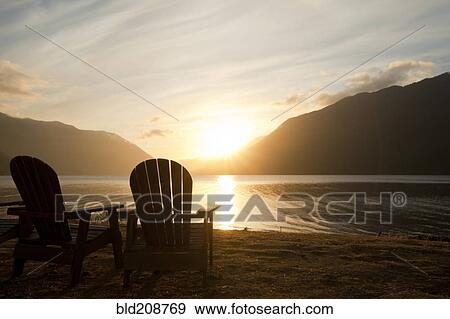 Two traditional Adirondack style wooden lounge chairs View Large Photo Image Stock Photo - Two traditional Adirondack style wooden lounge chairs. Fotosearch