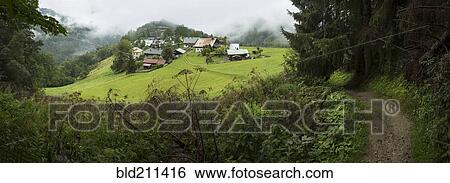 Stock Photograph - Village in green hills, Les Houcheas, France. Fotosearch
