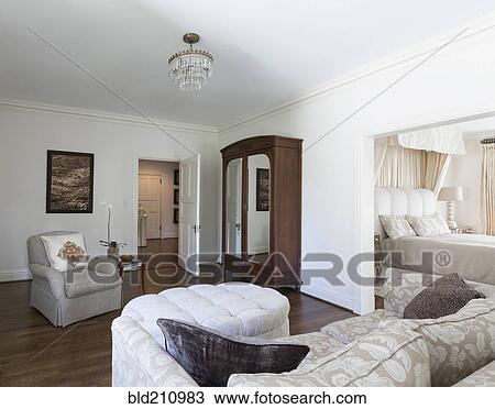 Stock Image - Wardrobe and sofa in ornate bedroom. Fotosearch