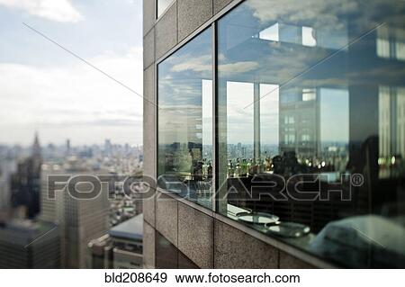 Stock Photo - Windows of highrise building overlooking city, Tokyo, Japan. Fotosearch