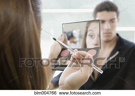 Stock Photograph - Woman applying makeup. Fotosearch