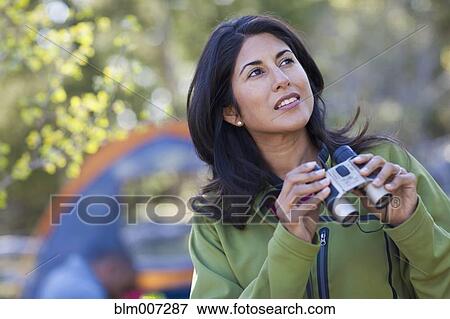 Woman camping and holding binoculars View Large Photo Image Stock Photo - Woman camping and holding binoculars. Fotosearch
