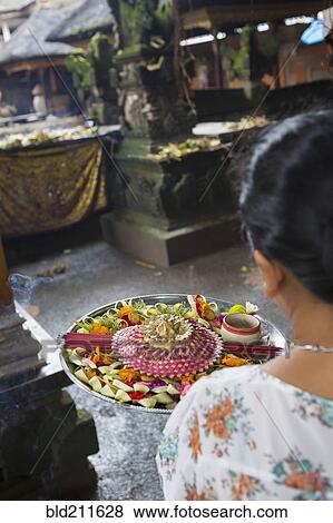 Stock Photo - Woman carrying tray, Ubud, Bali, Indonesia. Fotosearch