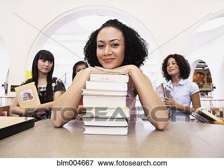 Woman checking out books from library View Large Photo Image Stock Photo - Woman checking out books from library. Fotosearch