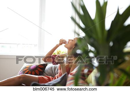 Woman drinking coffee in living room View Large Photo Image Stock Photography - Woman drinking coffee in living room. Fotosearch