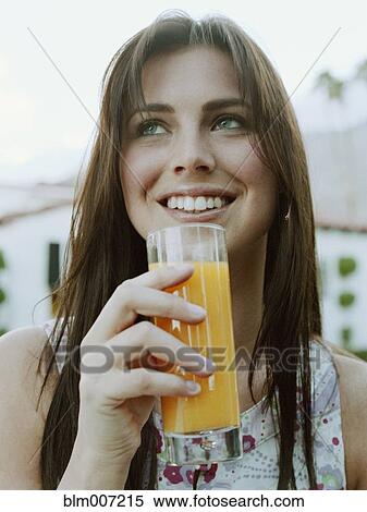 Stock Photography - Woman drinking orange juice. Fotosearch