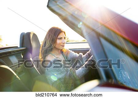 Woman driving convertible at sunset View Large Photo Image Picture - Woman driving convertible at sunset. Fotosearch