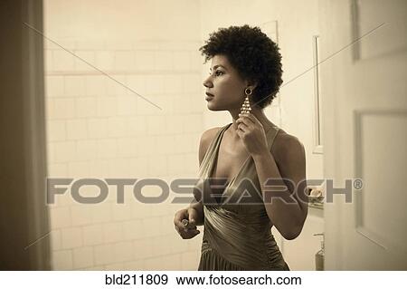 Woman getting ready in bathroom View Large Photo Image Stock Photo - Woman getting ready in bathroom. Fotosearch