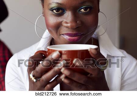 Stock Photograph - Woman having cup of coffee in cafe. Fotosearch