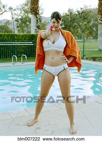 Woman in bikini aiming water gun View Large Photo Image Stock Image - Woman in bikini aiming water gun. Fotosearch
