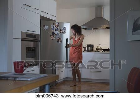 Woman in nightgown looking for food in refrigerator View Large Photo Image Stock Image - Woman in nightgown looking for food in refrigerator. Fotosearch