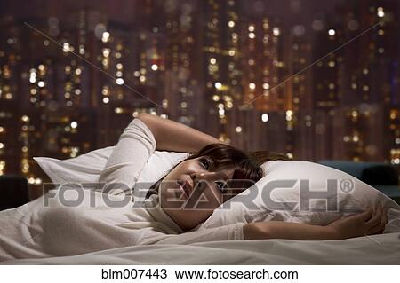Woman laying on bed View Large Photo Image Stock Image - Woman laying on bed. Fotosearch