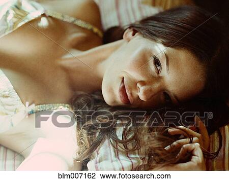 Stock Image - Woman laying on sofa. Fotosearch