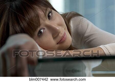 Woman leaning on table View Large Photo Image Stock Image - Woman leaning on table. Fotosearch