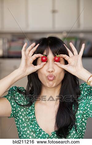 Woman playing with tomatoes View Large Photo Image Stock Photograph - Woman playing with tomatoes. Fotosearch