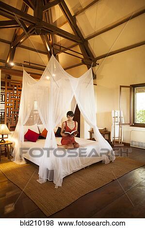 Woman relaxing in hotel room View Large Photo Image Stock Photo - Woman relaxing in hotel room. Fotosearch