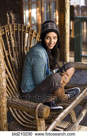 Woman sitting in armchair on porch View Large Photo Image Stock Image - Woman sitting in armchair on porch. Fotosearch