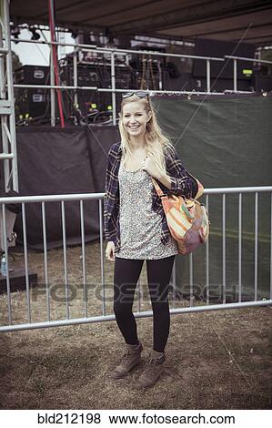 Stock Photo - Woman smiling at festival. Fotosearch