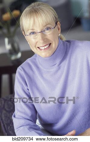Woman smiling indoors View Large Photo Image Picture - Woman smiling indoors. Fotosearch