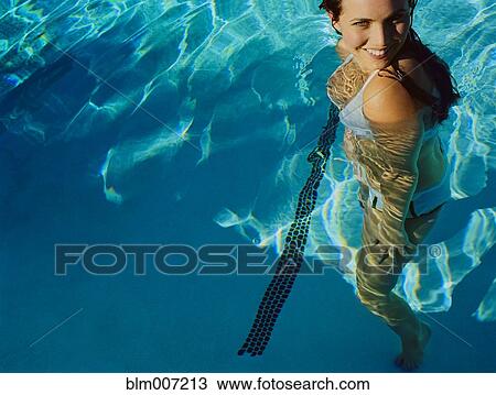 Woman standing in swimming pool View Large Photo Image Stock Image - Woman standing in swimming pool. Fotosearch