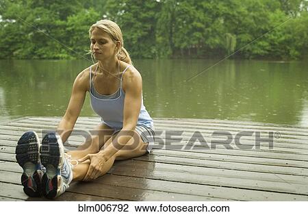 Woman stretching on pier View Large Photo Image Stock Image - Woman stretching on pier. Fotosearch