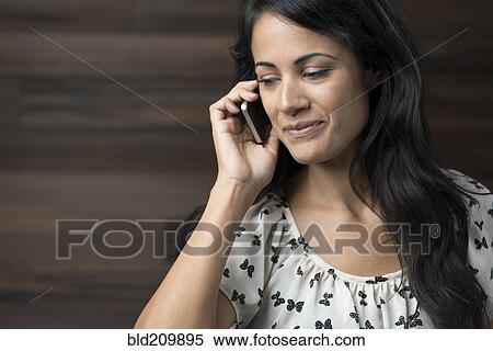 Woman talking on cell phone View Large Photo Image Stock Photography - Woman talking on cell phone. Fotosearch