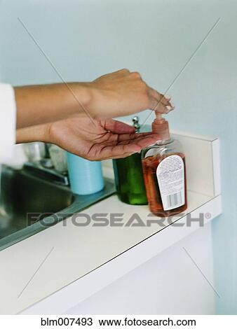 Woman using hand sanitizer View Large Photo Image Stock Image - Woman using hand sanitizer. Fotosearch
