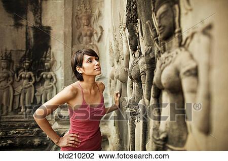 Woman visiting ancient temple, Angkor, Siem Reap, Cambodia View Large Photo Image Stock Image - Woman visiting ancient temple, Angkor, Siem Reap, Cambodia. Fotosearch