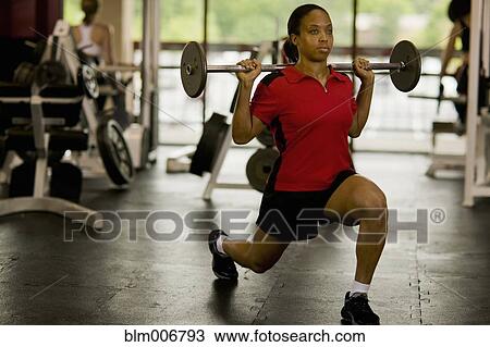 Woman weight lifting in health club View Large Photo Image Stock Image - Woman weight lifting in health club. Fotosearch