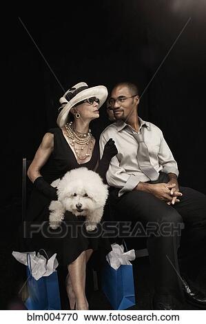 Woman with dog watching fashion show View Large Photo Image Stock Image - Woman with dog watching fashion show. Fotosearch