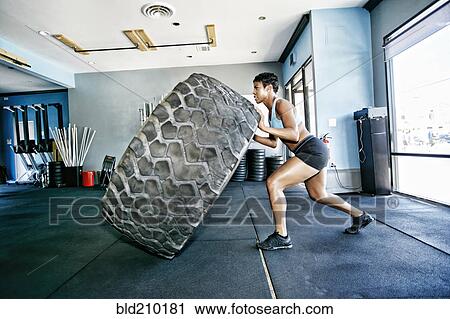 Woman working out in gym View Large Photo Image Stock Image - Woman working out in gym. Fotosearch