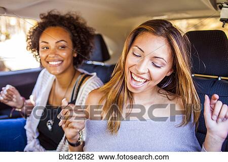 Women dancing together in car View Large Photo Image Stock Image - Women dancing together in car. Fotosearch