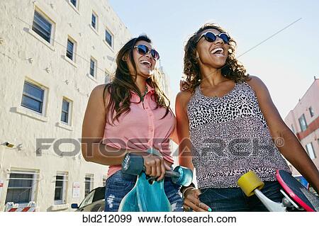 Stock Photo - Women laughing on city street. Fotosearch