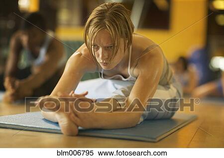 Stock Photography - Women practicing yoga in health club. Fotosearch