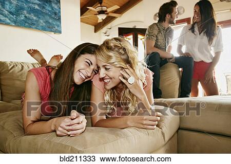 Women relaxing together on sofa View Large Photo Image Stock Image - Women relaxing together on sofa. Fotosearch