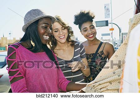 Stock Image - Women shopping on city street. Fotosearch