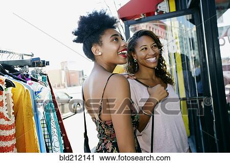 Stock Image - Women shopping on city street. Fotosearch